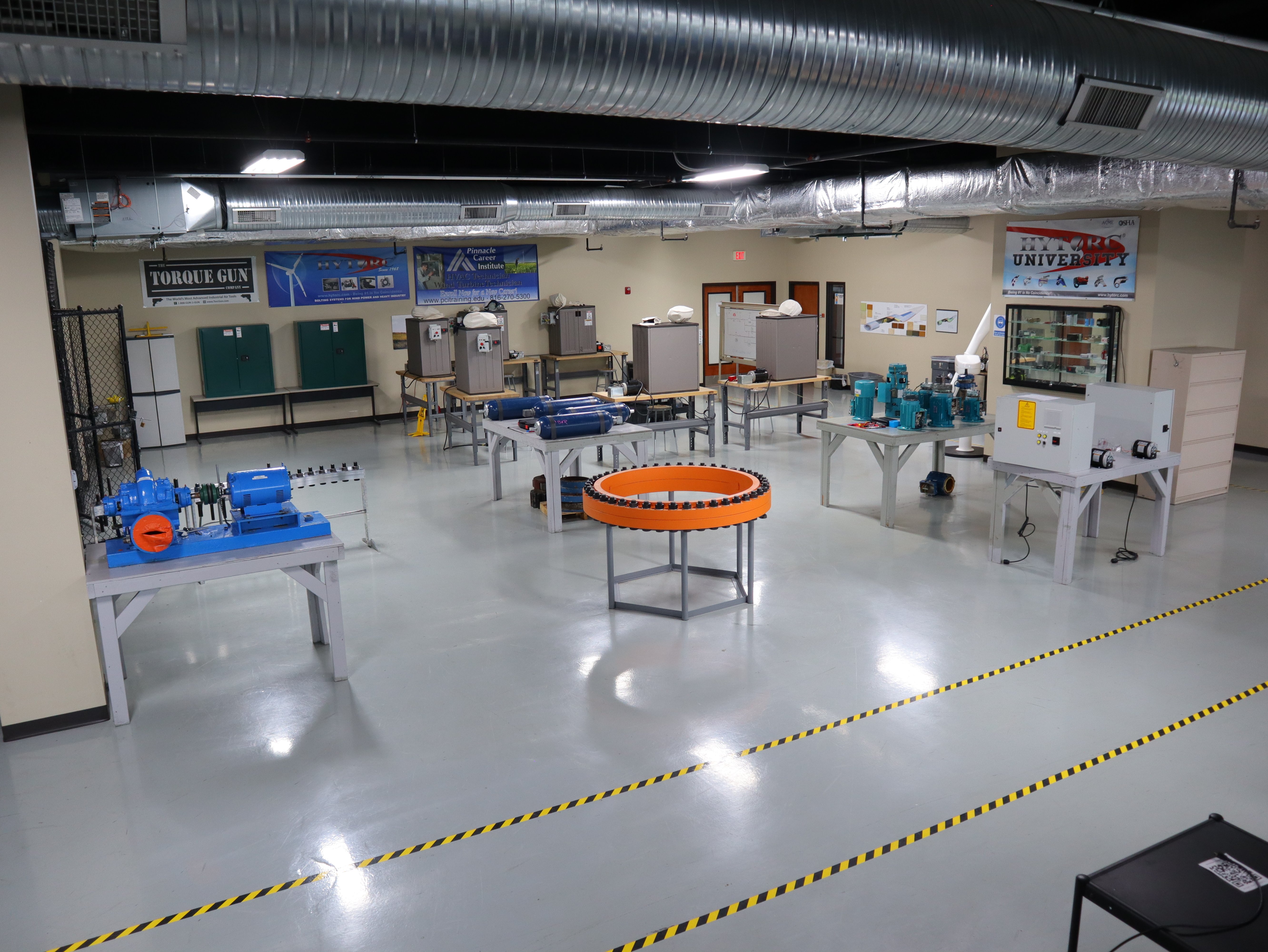 Pinnacle Career Institute’s GWO Bolt Tightening training lab featuring industrial torque tools, flange assemblies, and hands-on wind turbine safety equipment.