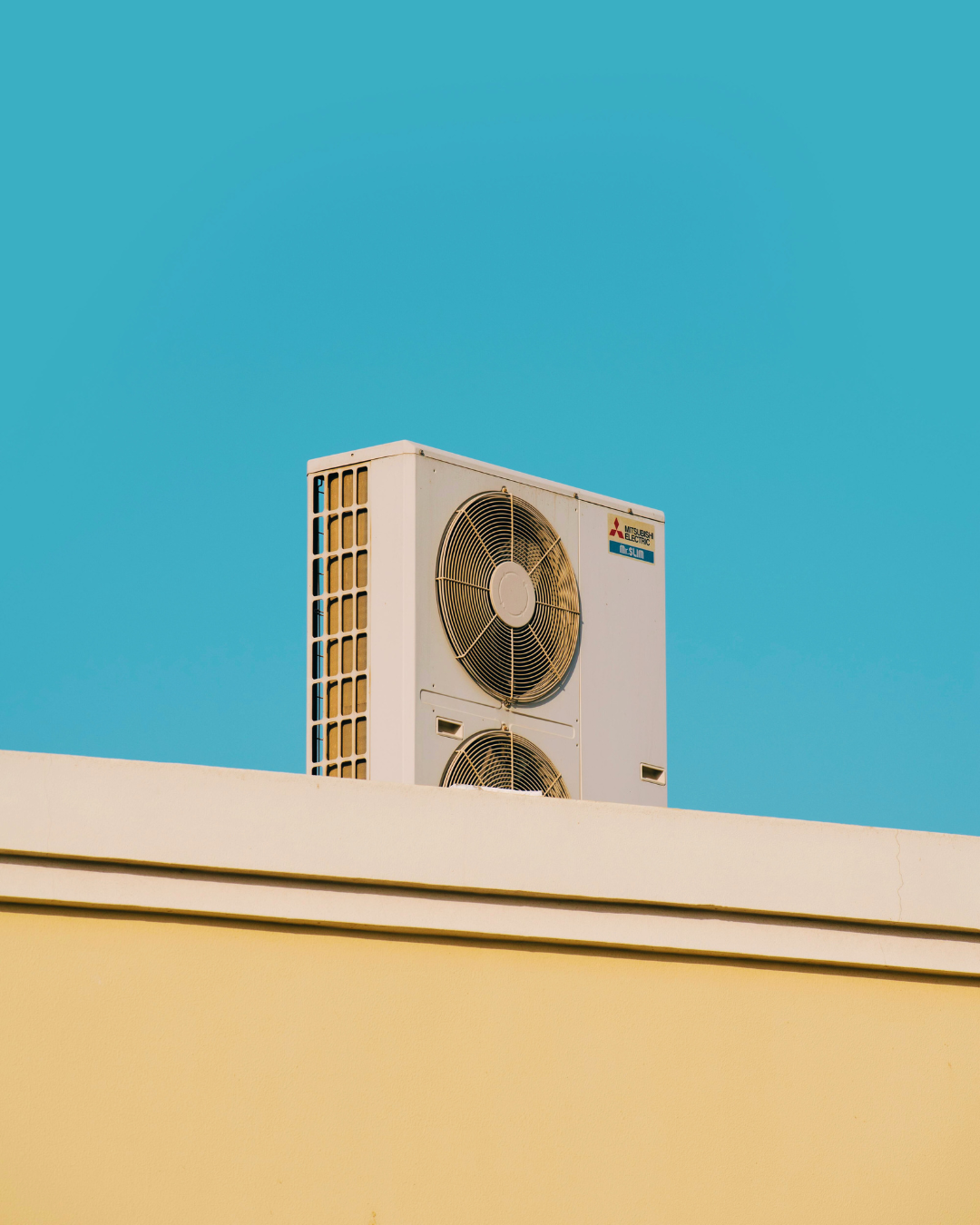 Outdoor HVAC unit installed on a rooftop under a clear blue sky.