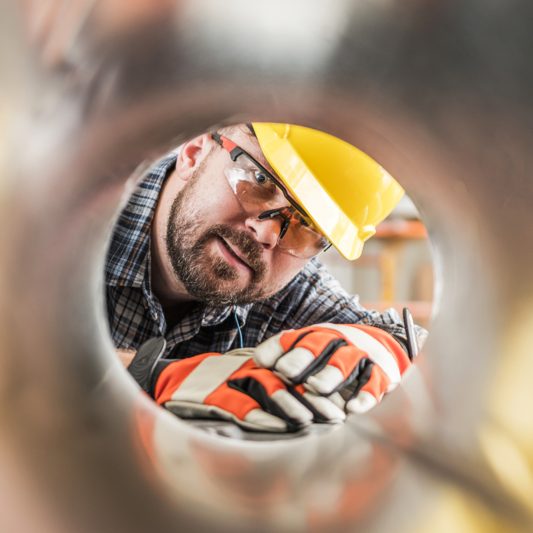 HVAC technician looking through ductwork during hands-on training at Pinnacle Career Institute.