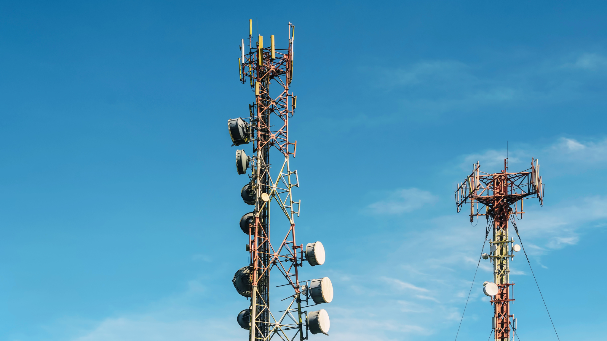 Telecommunications towers, on the left there is a self-supporting lattice telecommunications tower and on the right is a guyed lattice tower/mast
