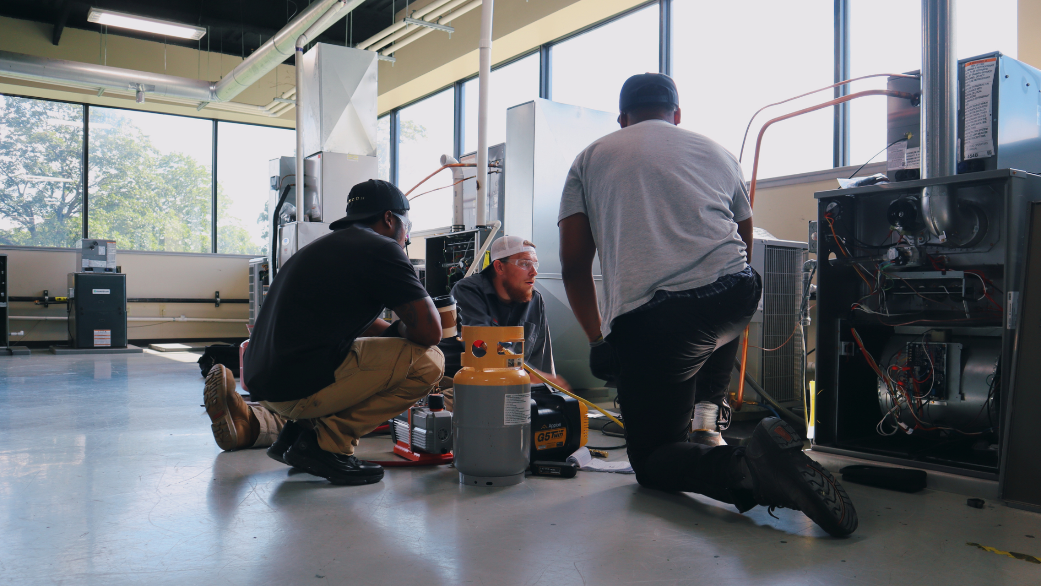 PCI HVAC students completing hands-on training with HVAC equipment in the Kansas City lab.