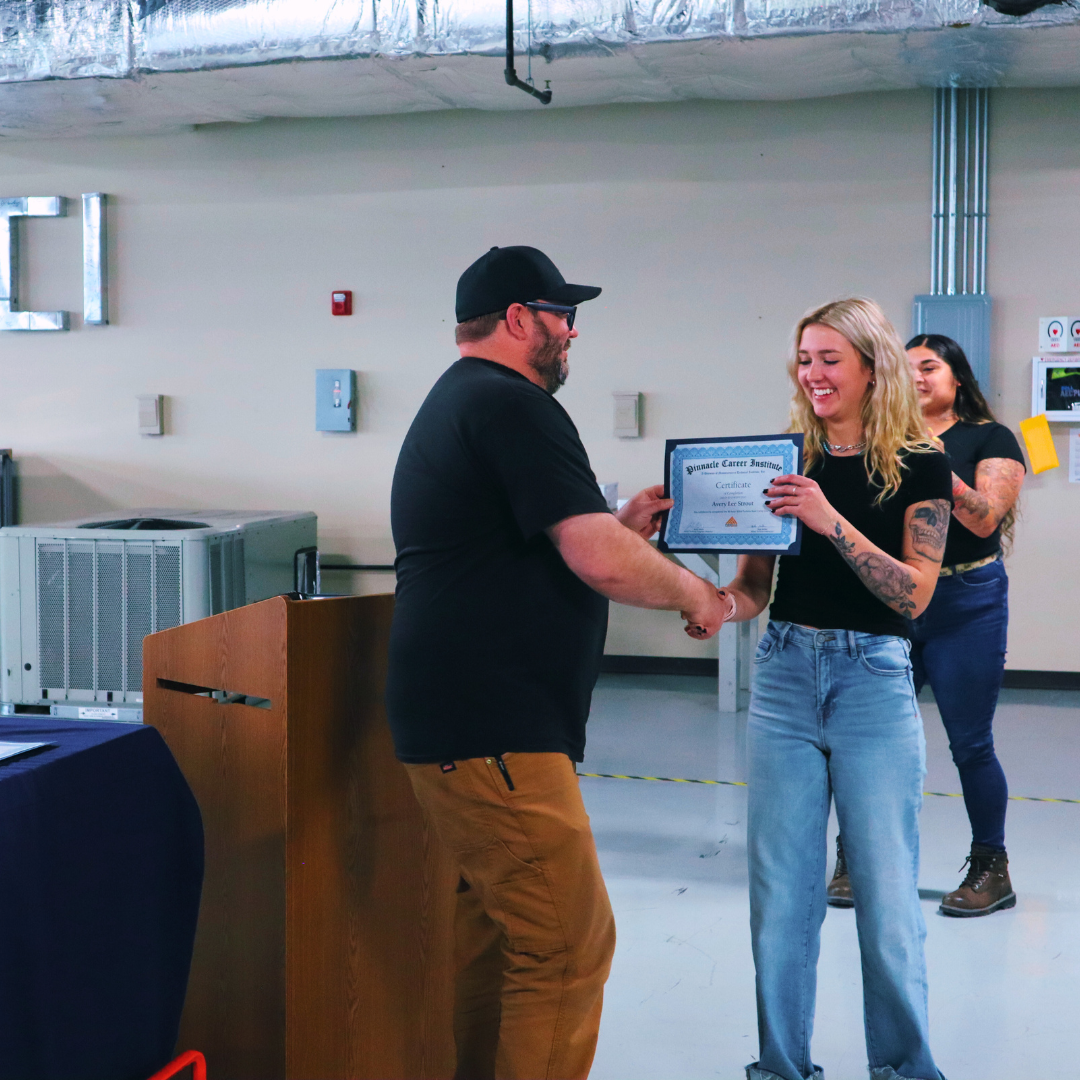 Pinnacle Career Institute student receiving boot camp certificate of completion.