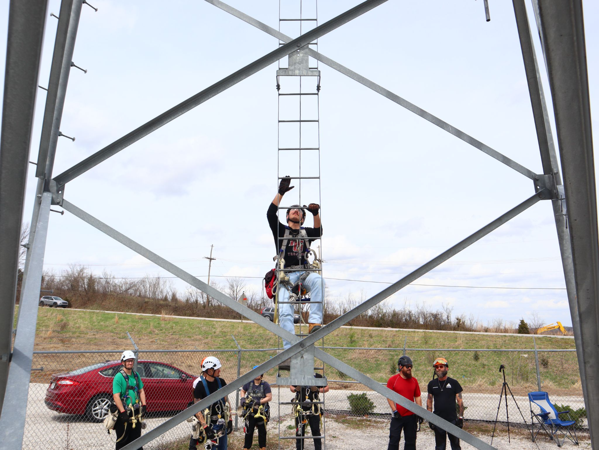 Students in PCI’s tower technician program practicing ladder climbs and rigging techniques on an outdoor training tower.