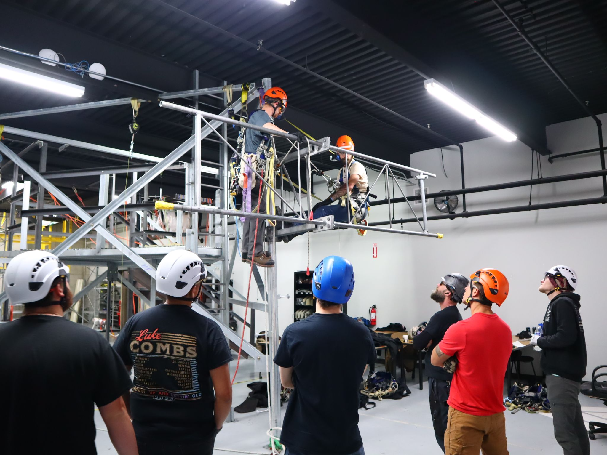 A group of tower technician trainees receiving instruction indoors at Pinnacle Career Institute’s training facility.