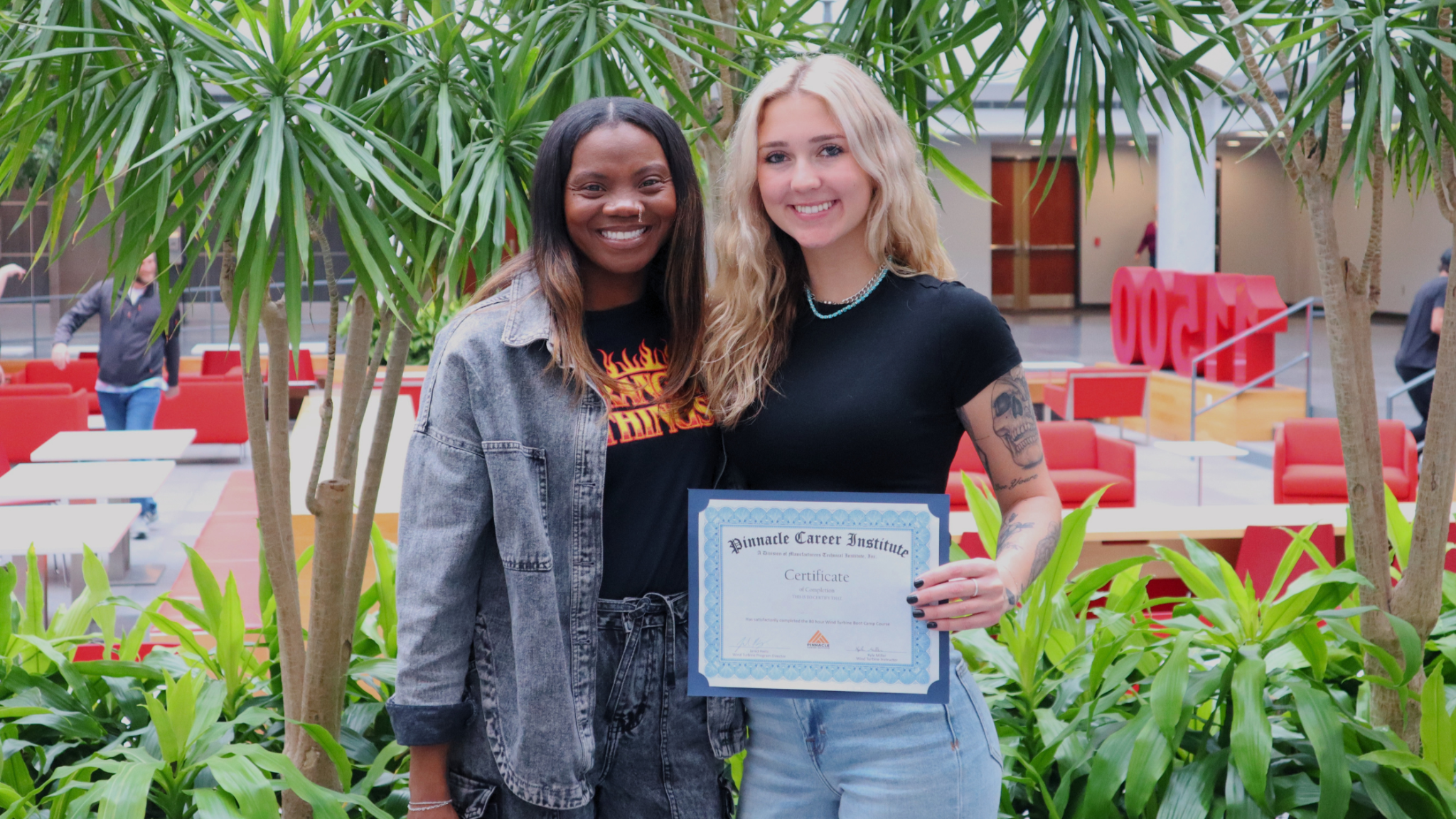 Student at Pinnacle Career Institute and her career services coordinator after completing boot camp in Kansas City, Missouri