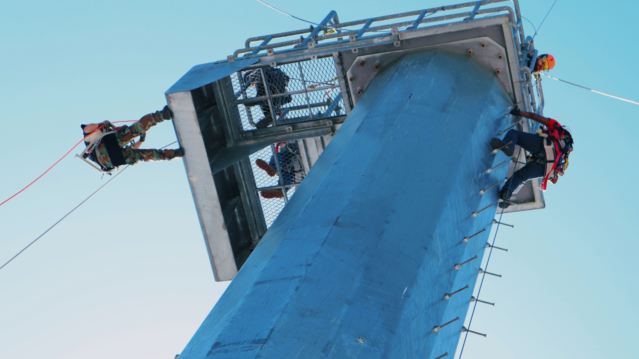 Tower technician students practicing climbing and fall protection on a monopole