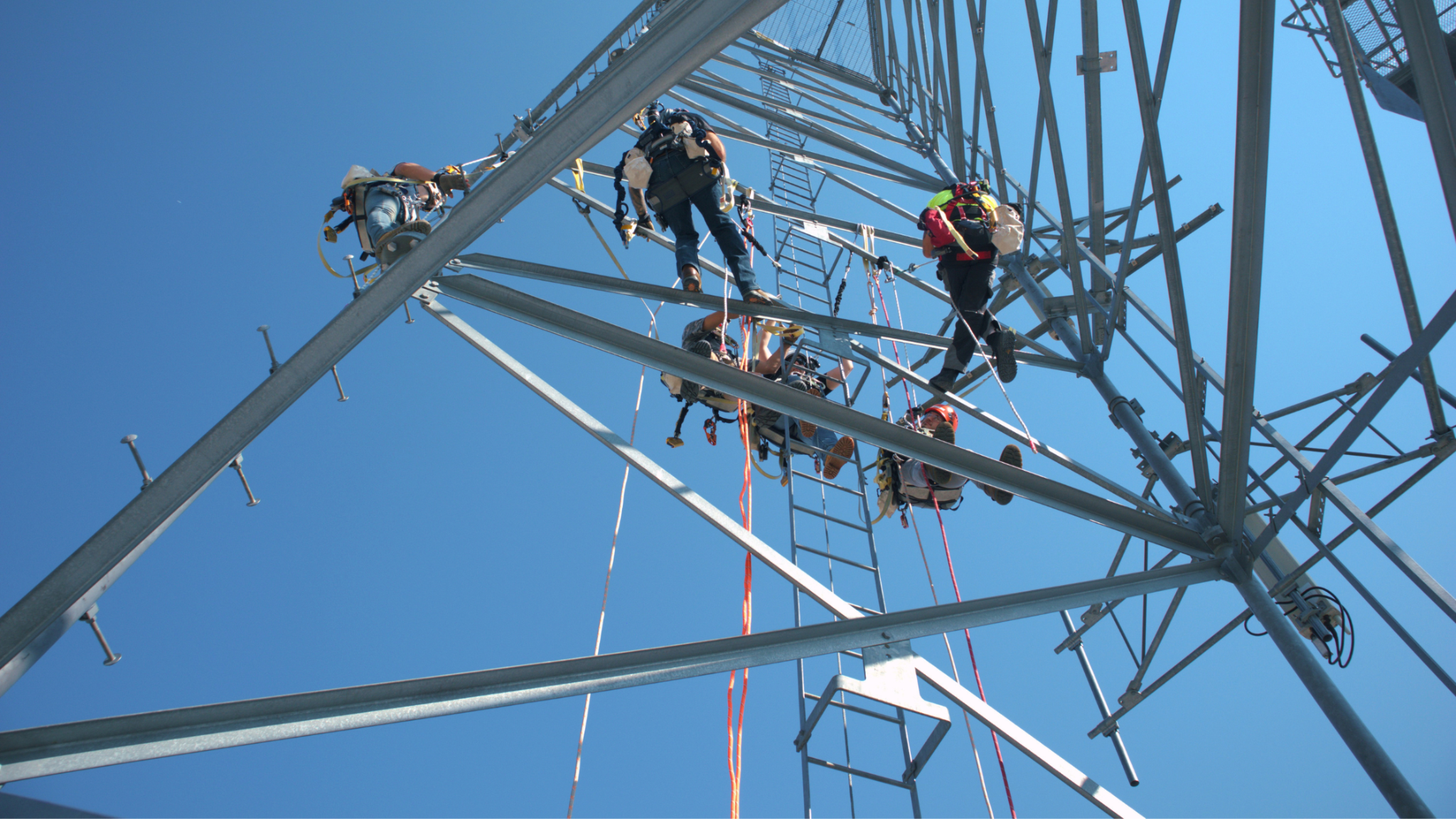 Tower technician students climbing a telecommunications training tower