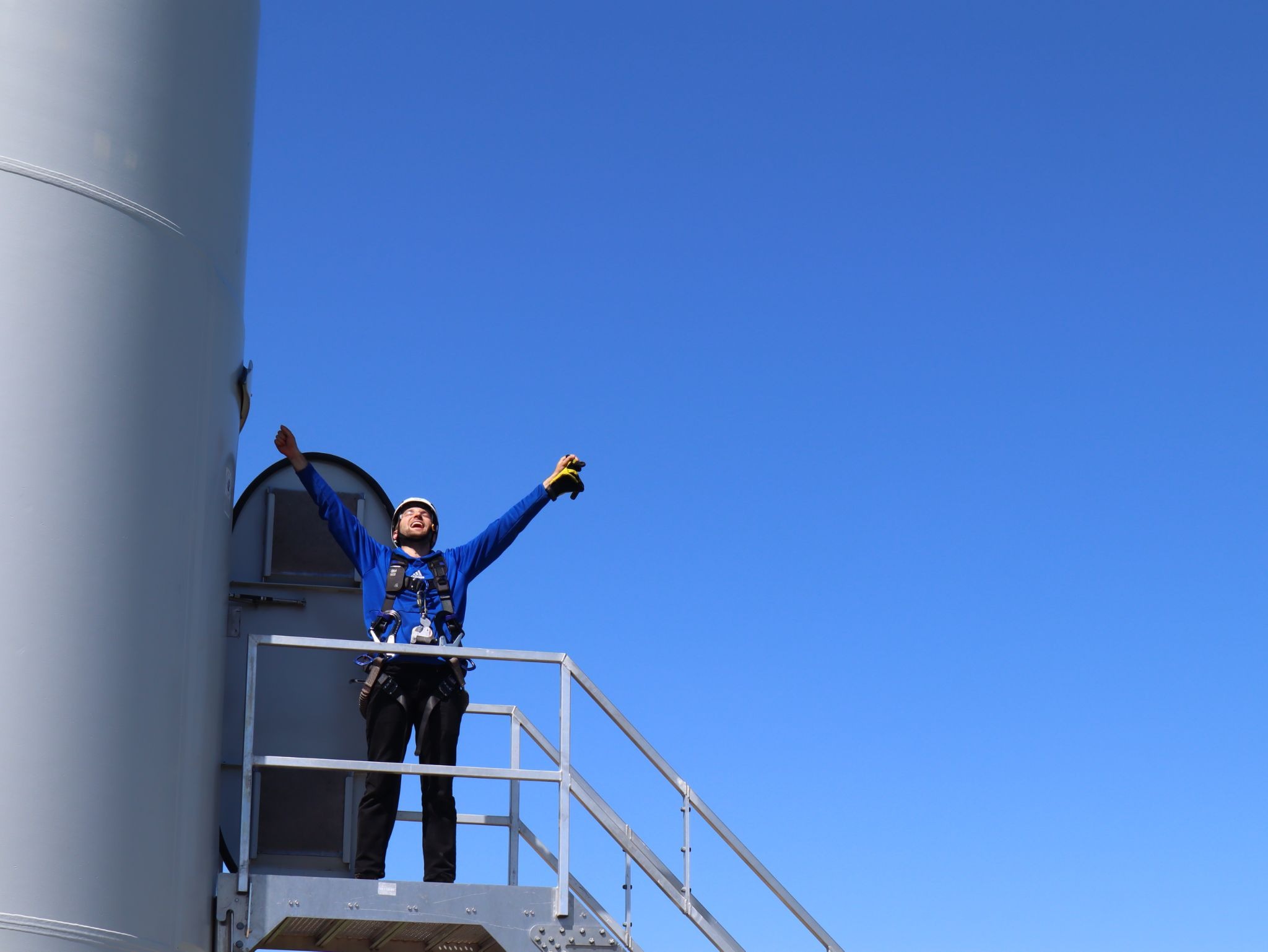 Pinnacle Career Institute staff after climbing a wind turbine.