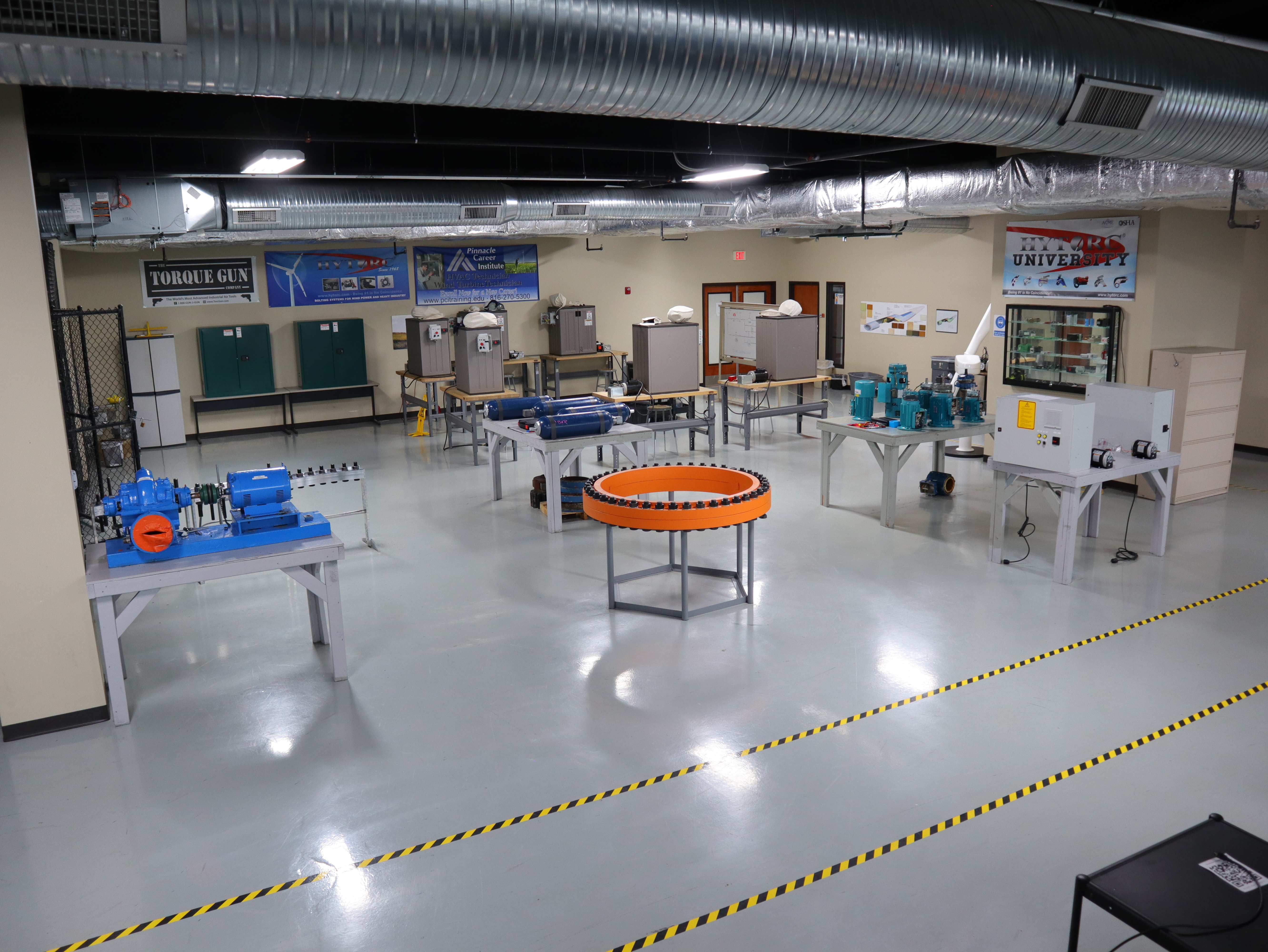 Pinnacle Career Institute’s GWO Bolt Tightening training lab featuring industrial torque tools, flange assemblies, and hands-on wind turbine safety equipment.